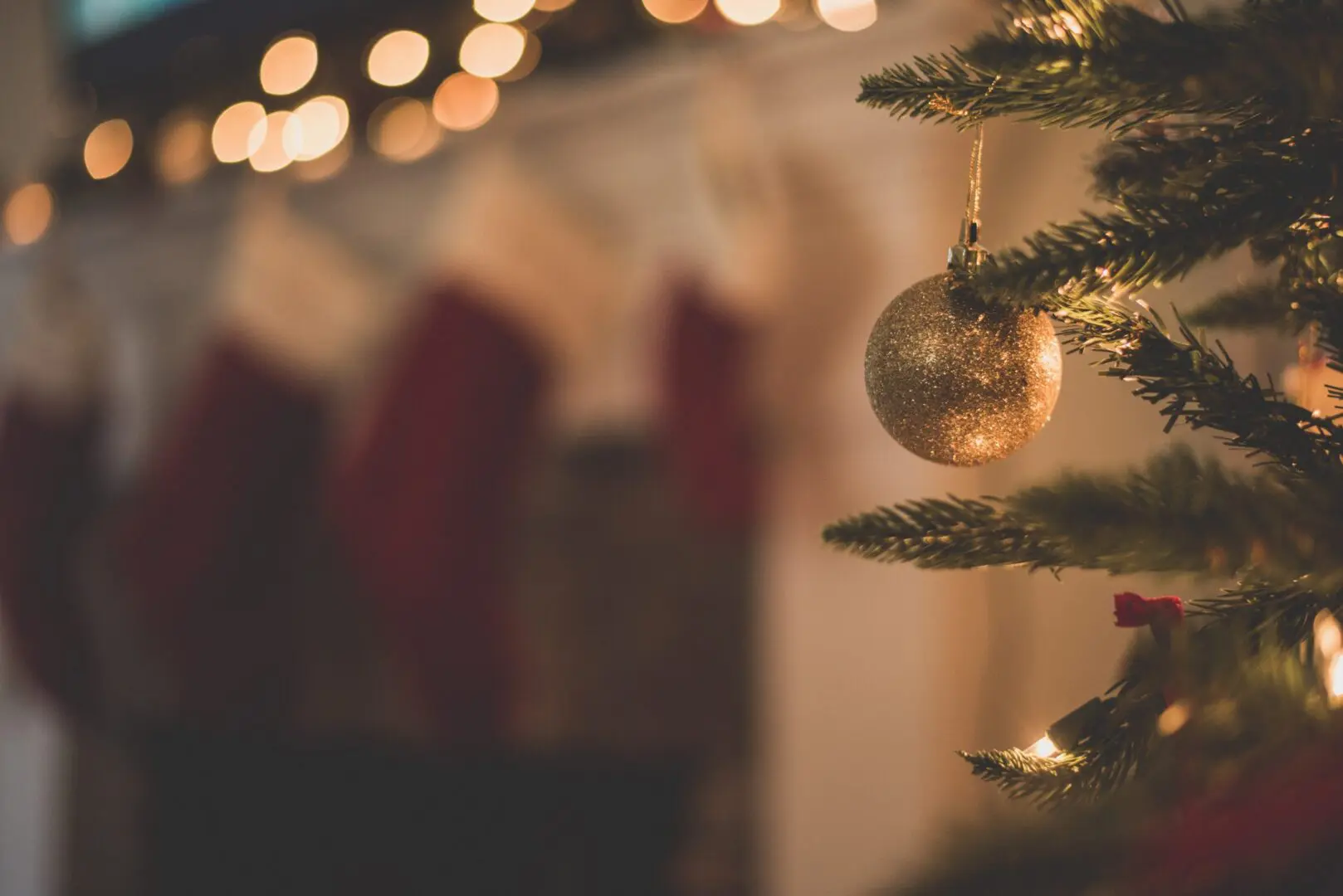 A gold bauble on a Christmas tree, representing winter holiday stress.