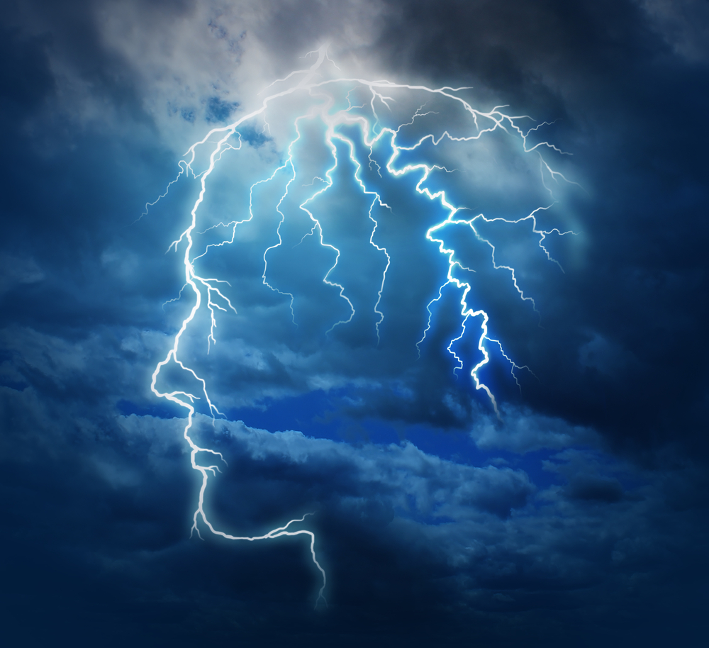 A dramatic stormy sky showcases lightning bolts outlining a human head profile against dark blue clouds, symbolizing the concept of ideas, innovation, or mental energy. The bright lightning creates an electric and thought-provoking atmosphere, reminiscent of breakthroughs that could occur in a trauma clinic.