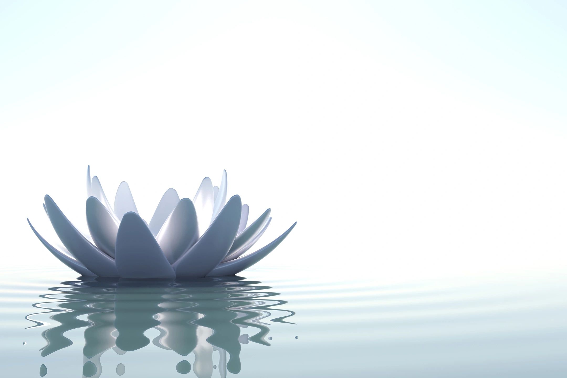 A serene image of a white lotus flower resting on calm water, symbolizing the peace found through mental health treatment at Khiron Clinics. The lotus petals are open, their reflection visible on the water's surface with gentle ripples surrounding the flower. The soft gradient of light blue and white creates a tranquil atmosphere.