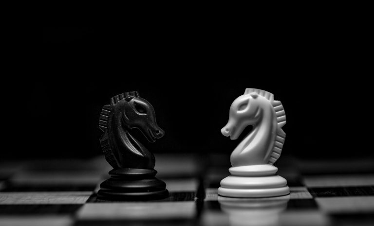 Two horses on a chessboard, representing compensatory strategies of trauma.
