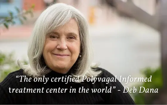 A person with long gray hair smiles while sitting outdoors. The text reads: “The only certified Polyvagal Informed treatment center in the world,” highlighting its professional accreditations - Deb Dana.