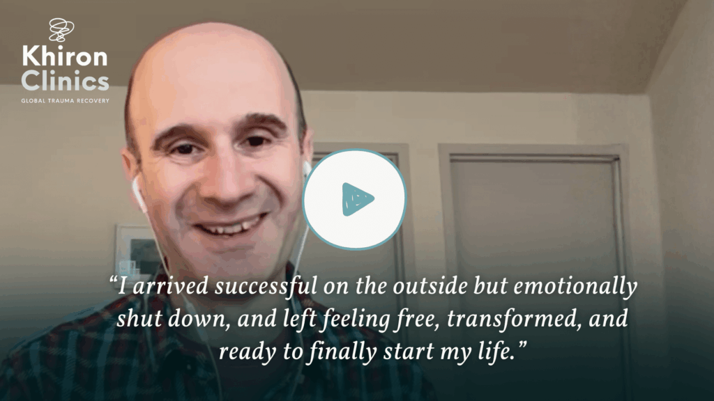 A smiling man with earphones appears in a video call. The Khiron Clinics logo is in the corner. Text reads: "I arrived asking, 'What is trauma?'—shut down inside, but left feeling free, transformed, and ready to finally start my life.”.