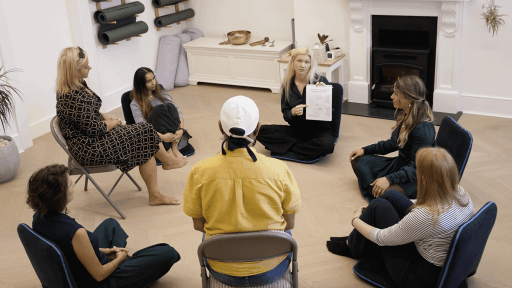 People in group therapy sitting in a circle being taught about trauma psychoeducation by a Khiron Clinics trauma therapist